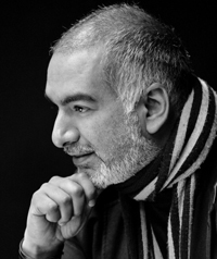 A man looks thoughtfully away from the camera