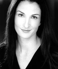 A black and white photo of a woman smiling at the camera