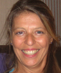A woman smiles at the camera