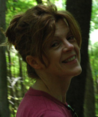 woman with brown hair up in the woods