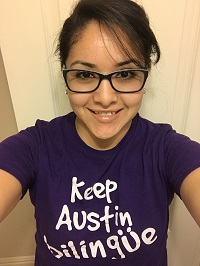 woman with brown hair and glasses wearing a shirt that says "Keep Austin Bilingual"