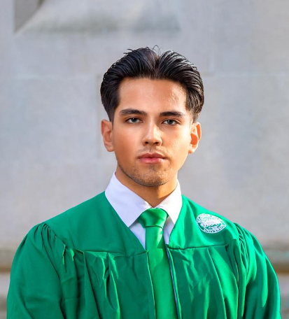 Mathew Hernandez wearing a green MSU graduation robe.