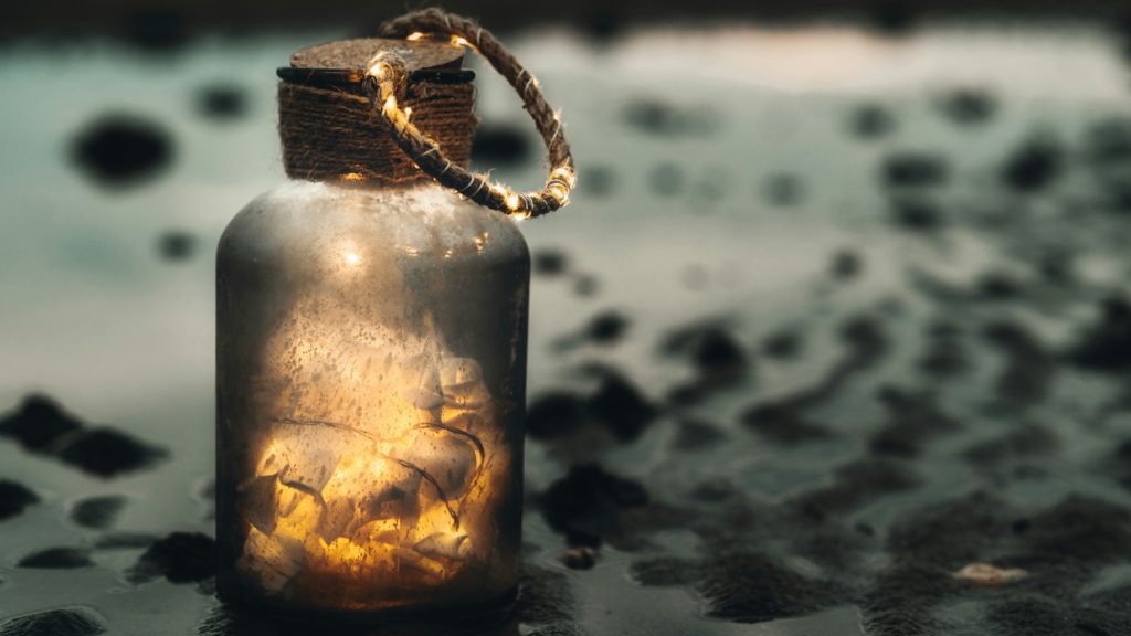A jar that is filled with a string of lights.