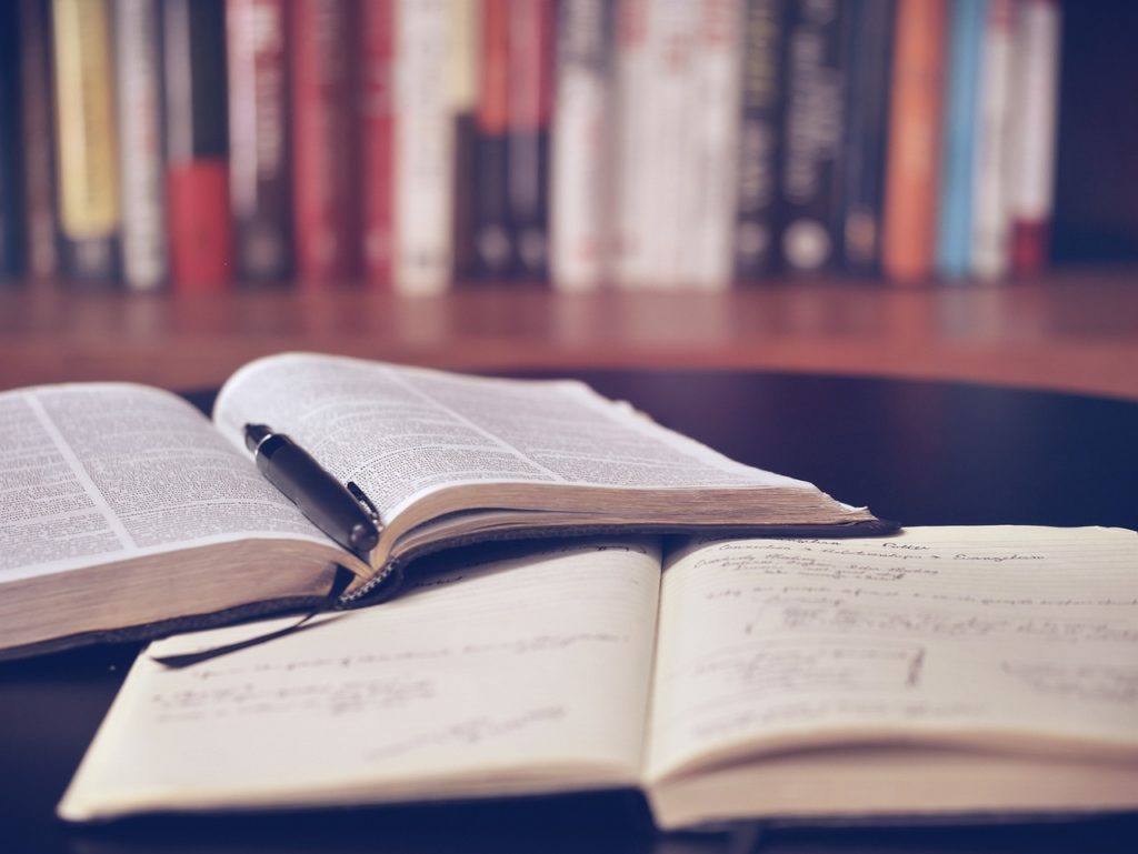 Books laying open on a desk