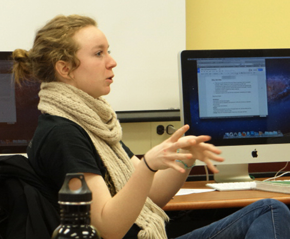 student talking near computer