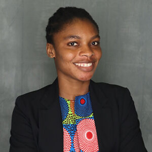 smiling woman wearing colorful blouse and black jacket