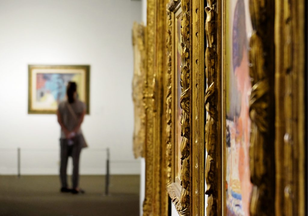 museum with paintings in intricate gold frames