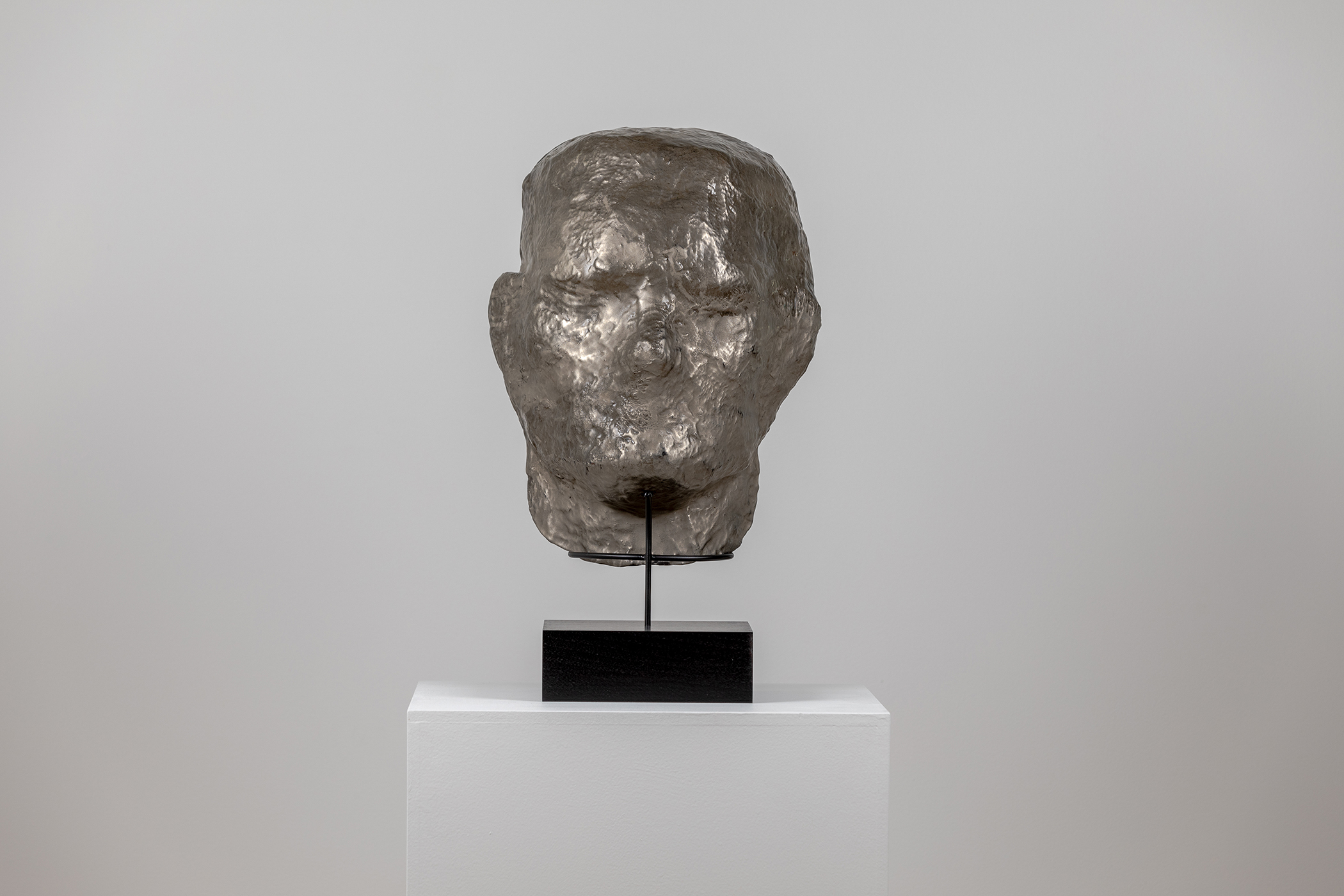 Spartan Skin (Face Mask); Cold-cast nickel silver, pigmented resin, acrylic paint, pigmented wax medium, steel, dyed walnut; 17” x 13” x 8 1⁄4”; 22 1⁄4” x 13” x 8 1⁄4” (with base)