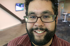 portrait of a man with black hair and glasses