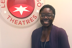 Adia Alli in front of League of Chicago Theatres sign