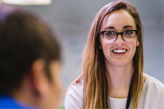 a women with long hair and wearing glasses