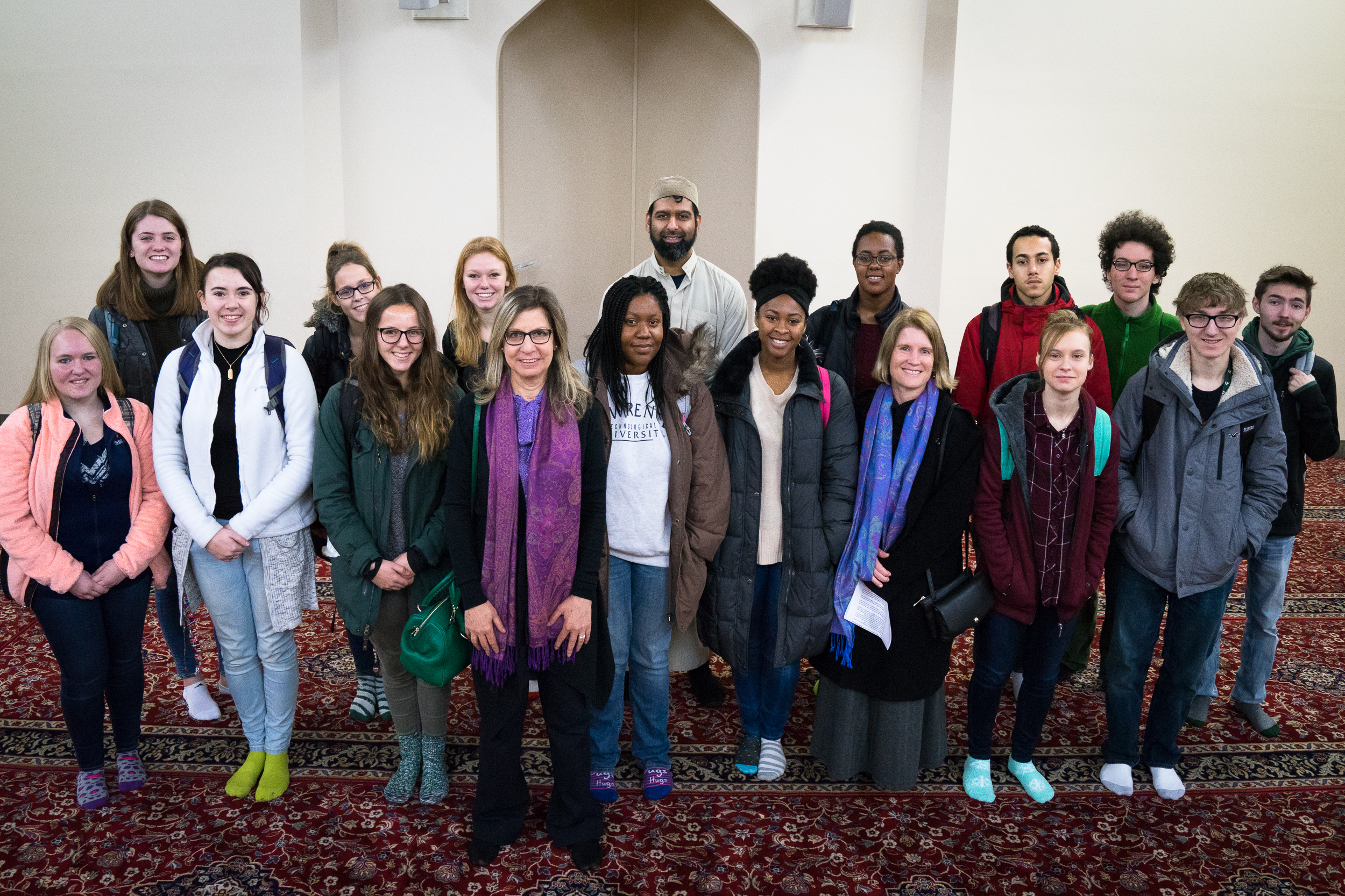 Middle eastern man standing in front of students