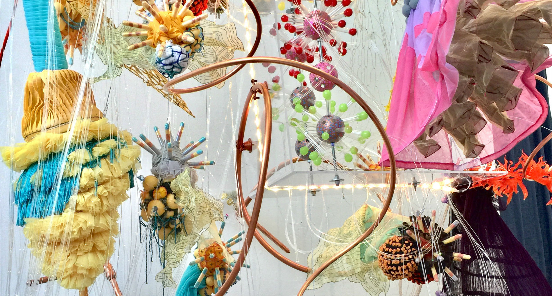 hanging pieces of a mixed media art piece