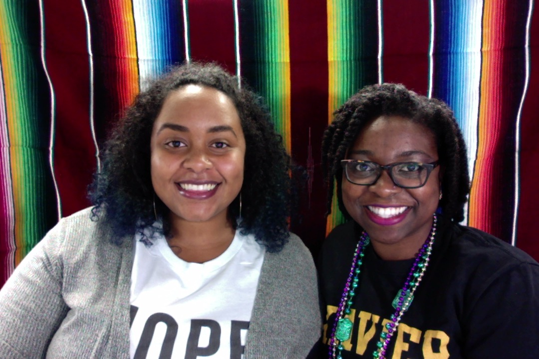 portrait of two women smiling next to each other
