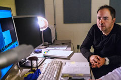 a man sitting at his desk with his computer and keyboard