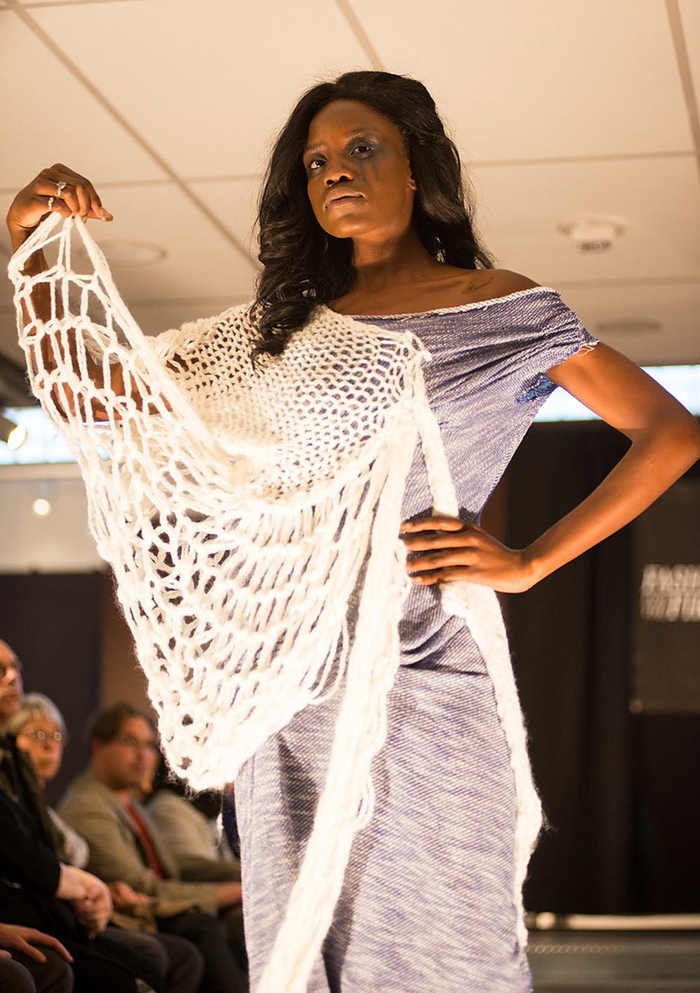 A model walks down the runway Saturday during the "Fashion for the Fire" fashion show at the Runway in downtown Lansing on S. Washington Square. The show's purpose is to raise proceeds to provide healing services to children who have survived sexual trauma in the community. Hannah Levy/The State News