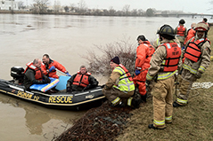 Photo of a group of first responders on a river bank in full uniform