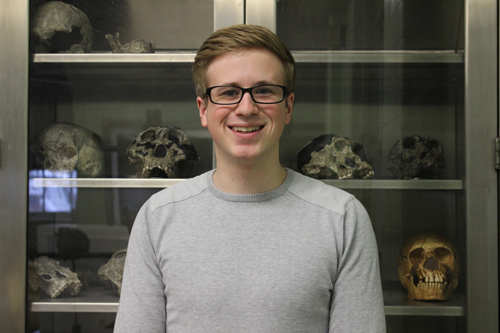 portrait of a man with blonde hair and glasses