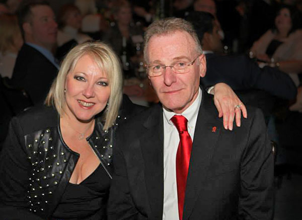 man in glasses posing with blonde woman