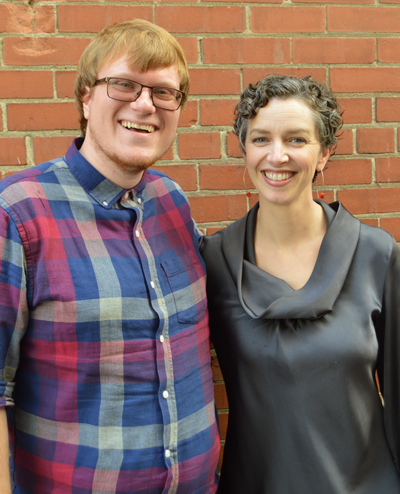 man with glasses and woman posing for picture