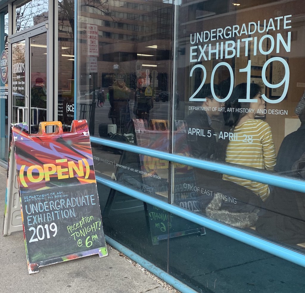 photo of a window that has a sticker that says 'undergraduate exhibition 2019'