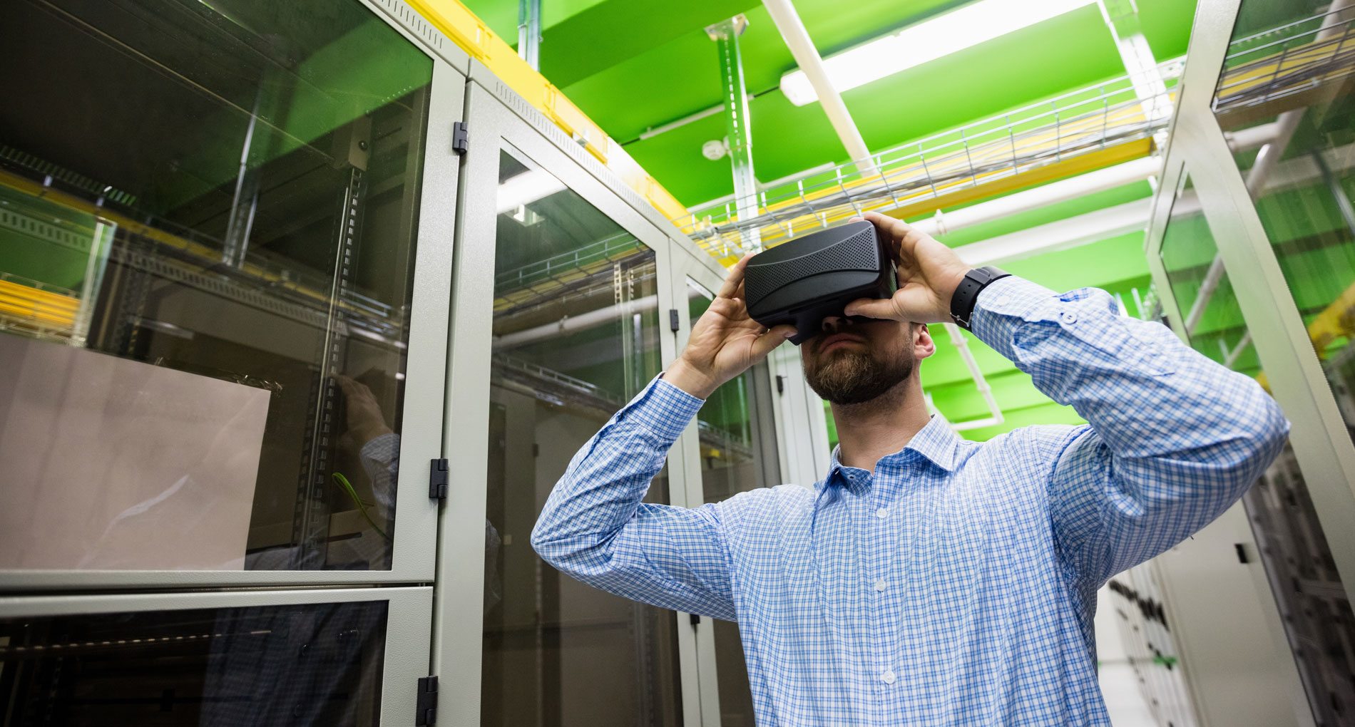a man holding a VR headset on his head