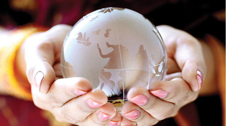 Hands holding a glass globe