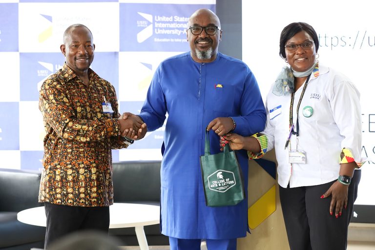 Jonathan Choti, Associate Professor in Michigan State University’s Department of Linguistics, Languages, and Cultures (left), shakes hands with United States International University-Africa Vice Chancellor Mwenda Ntarangwi (center) while Quin Awuor, Assistant Professor of Applied Linguistics at USIU-Africa (right), presents a Michigan State University College of Arts & Letters gift during the “Documentation and Scholarly Publishing of Kenyan Indigenous Languages” workshop in Nairobi, Kenya.
